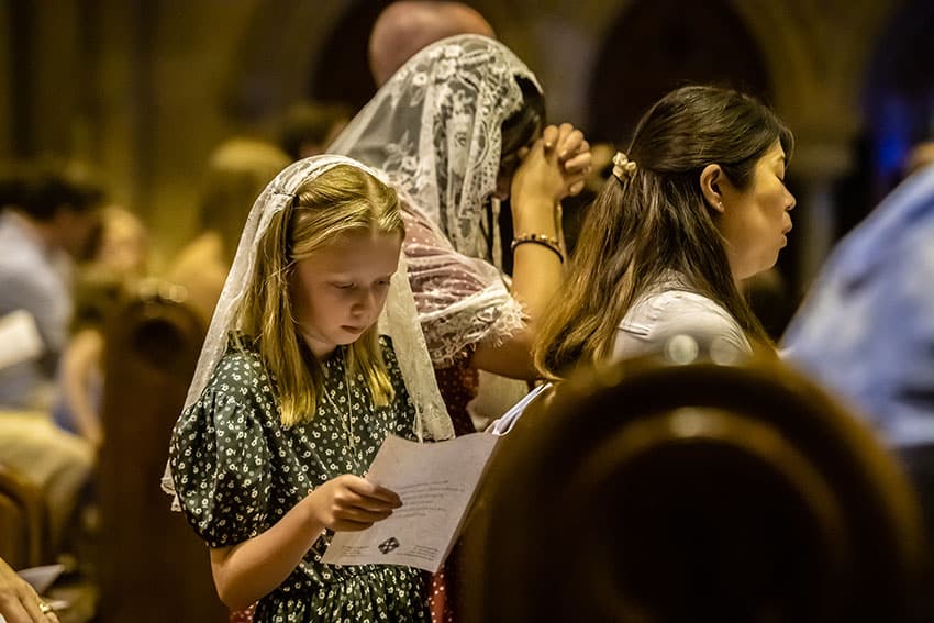 A worshipper kneels in prayer during the Mass of the Nativity in St Mary's Cathedral. Photo: Giovanni Portelli