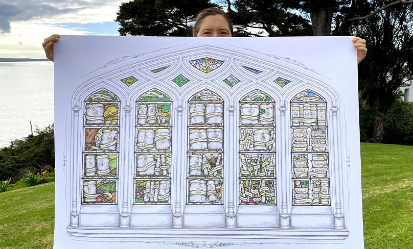 Obscured by her creation, Sister Jane Maisey holds an illustration of the books of the Bible as a stained glass window. Photo: Supplied