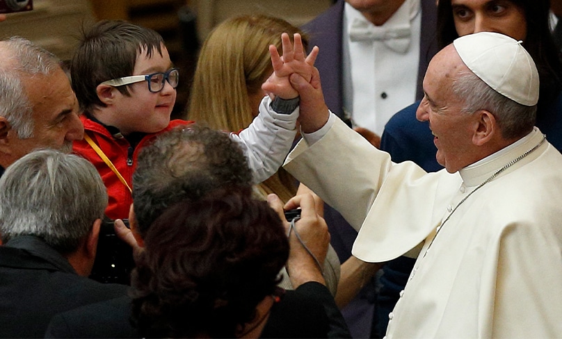 Pope Francis greets a child during an audience with people who have autism in the Paul VI Hall at the Vatican in 2015.Photo: CNS, Paul Haring
