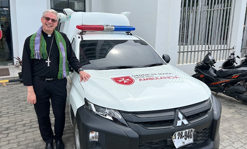 Bishop Richard Umbers stands beside the Lem Memorial Clinic’s ambulance in Timor-Leste’s capital, Dili. The ambulance has been provided by the Order of Malta in Australia. Photo: Nicole Chehine