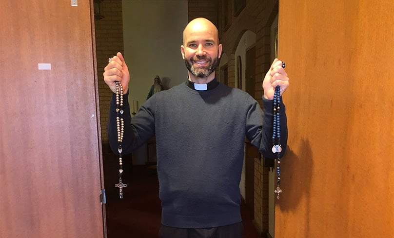 Father Reece Beltrame holds Rosary beads. Facing serious illness, he finds devotions such as the Rosary especially helpful and has been promoting it to families across the Wagga Diocese. Photo: Supplied