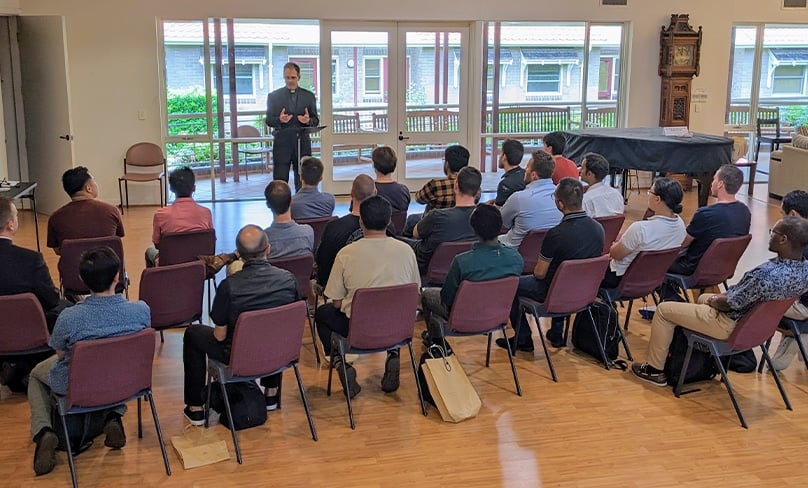 Men interested in the possibility of discerning their vocations further in the context of seminary life listen as Rector Fr Michael de Stoop talks about what is involved. Photo: Supplied