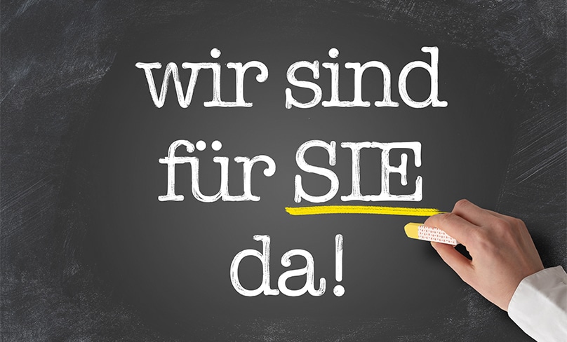 Words in German on a blackboard read: we are there for you. Photo: CH. HORZ, 123RF