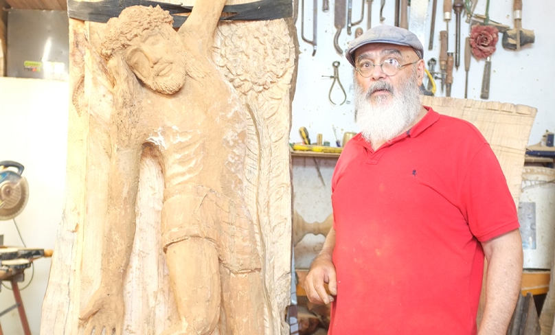 Sculptor Toufic Mourad, pictured in his workshop, spent more than two months painstakingly carving a magnificent reliquary from a single piece of cypress in his Canterbury studio in Sydney’s inner west. Photo: Supplied