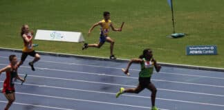 Divine Chukwudi, at right, leads for the finishing line in the Under-13 100 metres Australian Junior Championships. Photo: Supplied