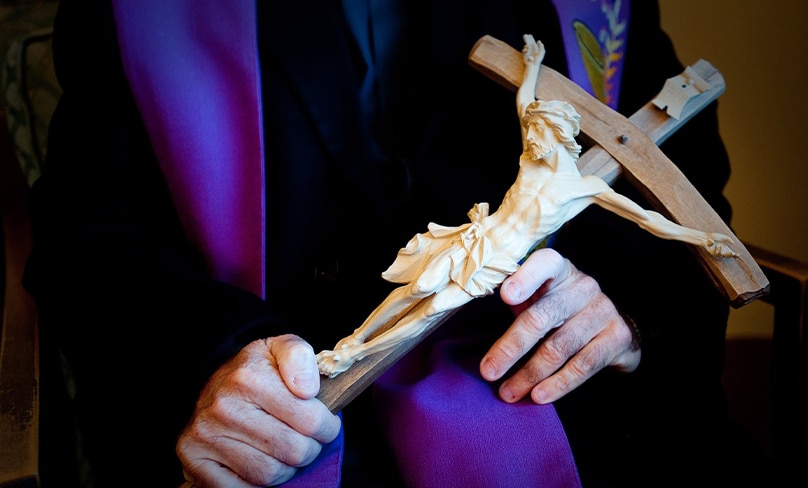 Father Gary Thomas, pastor of Sacred Heart Church in Saratoga, Calif., holds a crucifix Oct. 31 he uses in performing an exorcism. Father Thomas' training as an exorcist is recounted in a 2009 nonfiction book titled "The Rite: The Making of a Modern Exorcist," and now the book is being made into a feature film starring Anthony Hopkins. Photo: CNS/Don Feria
