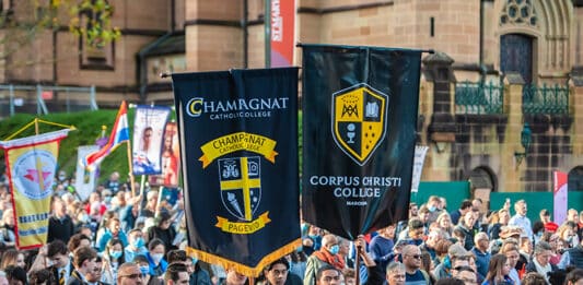 Students process through the streets under their school banners during the Walk for Christ on the feast of Corpus Christi in 2022. A new documentary will help Catholics prepare for the feast on 11 June this year. Photo: Giovanni Portelli