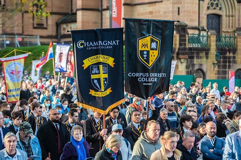 Students process through the streets under their school banners during the Walk for Christ on the feast of Corpus Christi in 2022. A new documentary will help Catholics prepare for the feast on 11 June this year. Photo: Giovanni Portelli