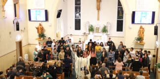 Fr Delmar Silva CS blesses international students at a Spanish-language Mass held at St Michael’s, Hurstville, on Saturday 29 April. Photo: Adam Wesselinoff