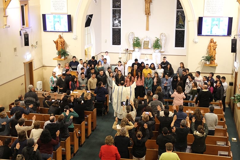 Fr Delmar Silva CS blesses international students at a Spanish-language Mass held at St Michael’s, Hurstville, on Saturday 29 April. Photo: Adam Wesselinoff