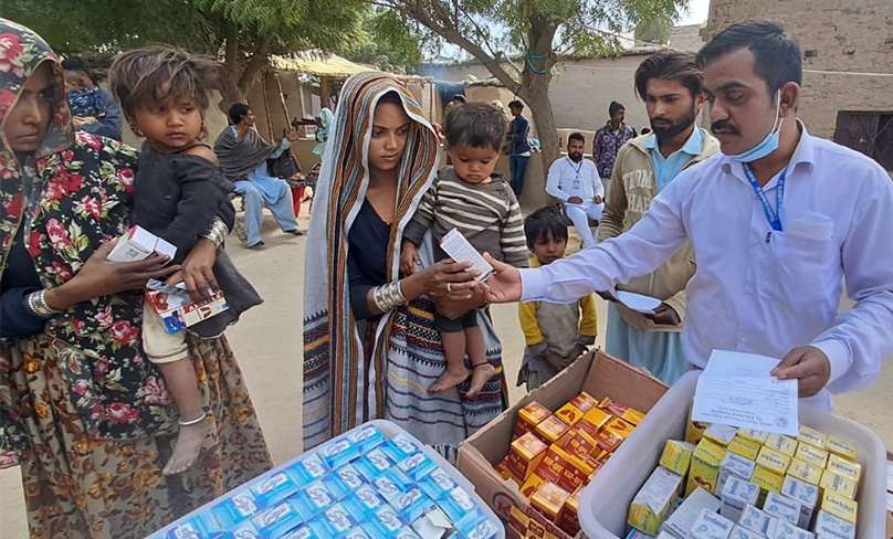 A Doctors hands out medical supplies at a mobile camp in Pakistan. Photo: Courtesy of St Elizabeth's Hospital in Hyderabad