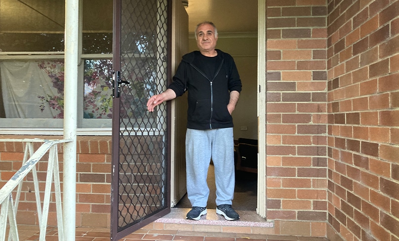 Sam Ali waits to welcome Tony Cranney who came by to deliver a couch for his home. Photo: Supplied