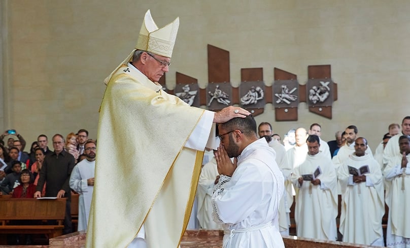Archbishop Timothy Costelloe SDB lays his hands over Fr Sheldon Burke CRS during his ordination to the priesthood at St Mary's Cathedral, Perth, on 17 June. Photo: Ron Tan/Archdiocese of Perth