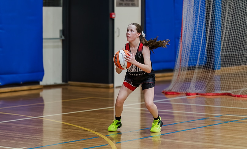 11-year-old Sienna Livermore was told she’d never walk again after a diagnosis of septic arthritis, but prayer, determination and family has her shooting three-pointers again. Photo: Patrick Lee