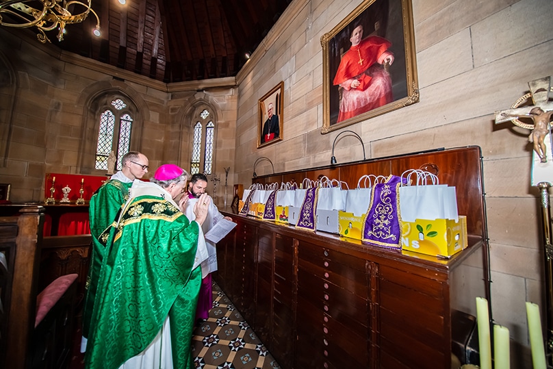 Archbishop Anthony Fisher OP blesses one-of-a-kind stoles, designed for World Youth Day Lisbon, which will be worn by each chaplain as they offer the sacraments to the pilgrims under their spiritual care. Photo: Giovanni Portelli