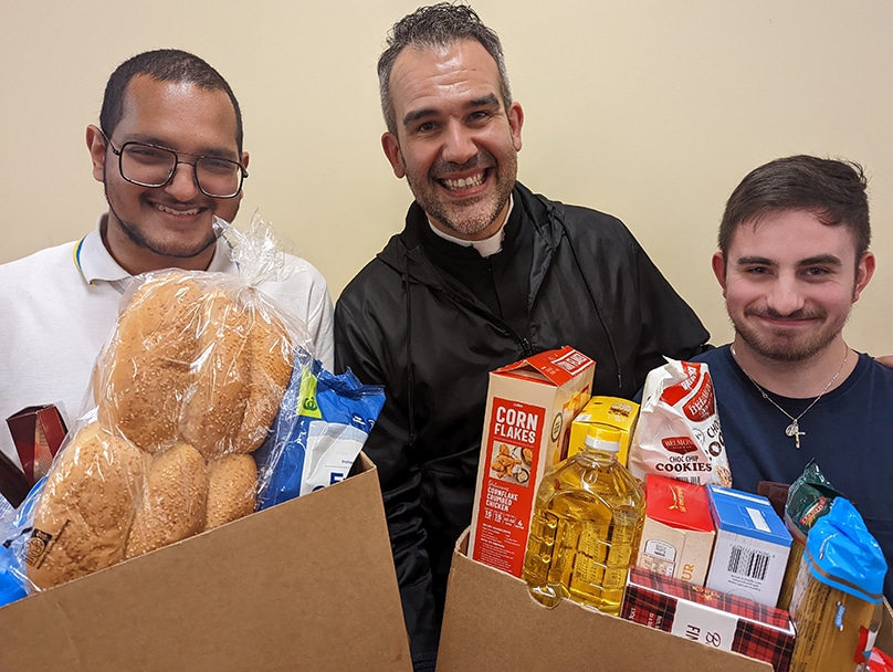 Fr Chris de Sousa CRS and volunteers from Miani Meals prepare hampers for struggling families in Sydney’s west. Photo: Somascan Missions
