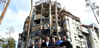 ACBC delegation at a destroyed building in Irpin, a town on the outskirts of Kyiv. Photo: Annie Carrett/Melbourne Catholic