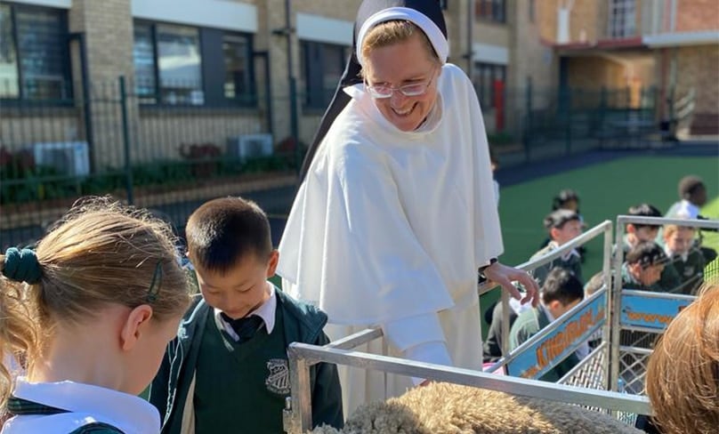 Sr. Cecilia Joseph, OP woth students at St. Peter Chanel Catholic Primary School in Regents Park. Photo: Supplied
