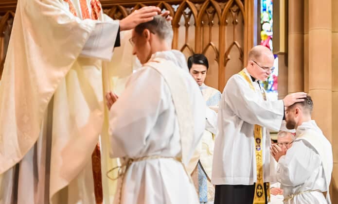 Clergy from the Sydney Archdiocese lay their hands over Rev. Richard Sofatzis and Matthew Lukaszewicz during their Ordination to the Priesthood at St Mary’s Basilica, Sydney, 9 September 2023. Photo: Giovanni Portelli