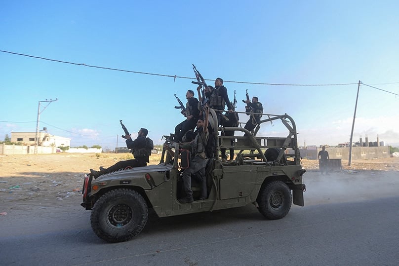 Palestinian militants ride an Israeli military vehicle that was seized by gunmen who infiltrated areas of southern Israel, in the northern Gaza Strip 7 October. Photo: OSV News photo/Ahmed Zakot, Reuters