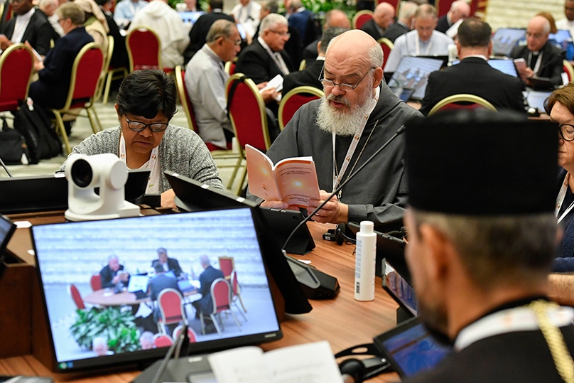 Participants at the assembly of the Synod of Bishops recite morning prayer before finishing their discussions on the assembly's first module, which was on the meaning of synodality and how to promote it in the church, in the Vatican's Paul VI Audience Hall on 7 October 2023. Photo: CNS photo/Vatican Media