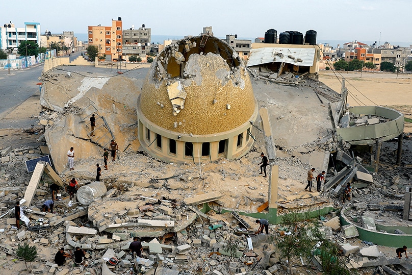 Palestinians inspect a mosque destroyed in Israeli strikes in Khan Younis, in the southern Gaza Strip, 8 October, 2023. Photo: OSV News photo/Ibraheem Abu Mustafa, Reuters