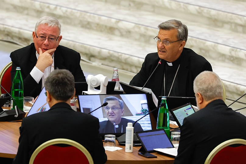 Cardinal Jean-Claude Hollerich, relator general of the synod, listens as Cardinal Mario Grech, secretary-general, introduces the beginning of the assembly of the Synod of Bishops' work in the Vatican's Paul VI Audience Hall 9 October 2023. Photo: CNS photo/Lola Gomez