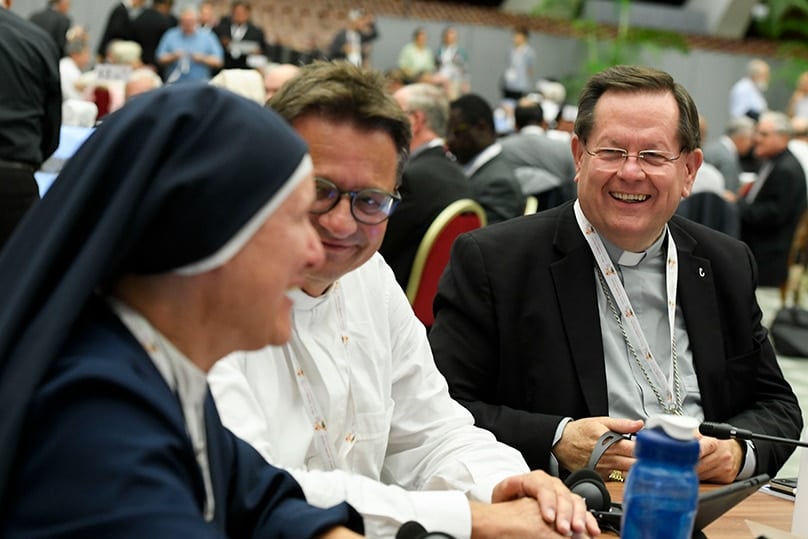 Canadian Cardinal Gérald C. Lacroix of Québec smiles with other members of his small group during the assembly of the Synod of Bishops 11 October 2023, in the Paul VI Audience Hall at the Vatican. Photo: CNS photo/Vatican Media