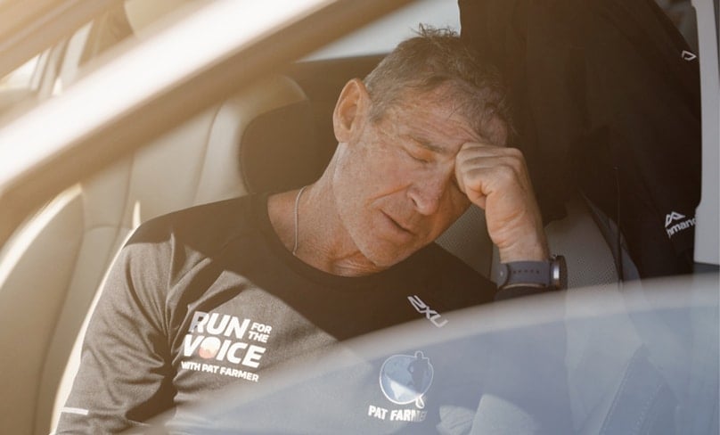Footsore and exhausted, Pat Farmer takes a well-earned rest. Photo: Supplied