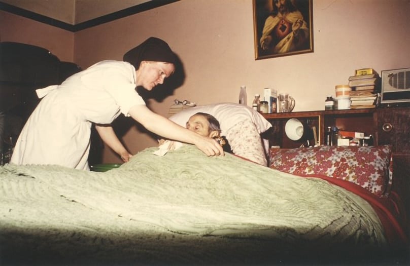 A young Sr Margaret Mary Birgan oln attending to an elderly patient ‘on the district.’ Photo: Supplied