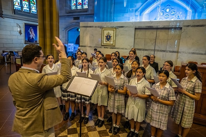 Jubilate Deo director Ronan Reilly, pictured conducting students at St Mary’s Cathedral, said Sydney was unique in its co-ordinated effort to make Pope Paul VI’s vision of a chant repertoire for lay Catholics a reality. Photo: Giovanni Portelli