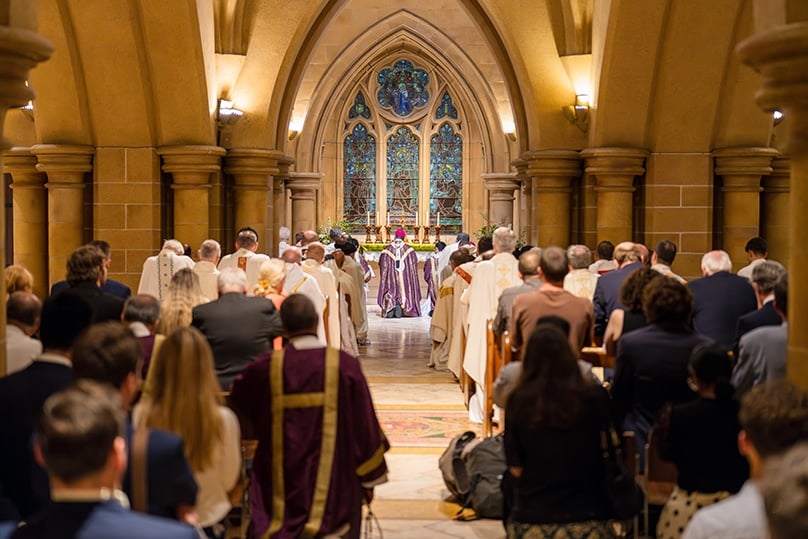 In a touching moment at the end of the Mass, the entire congregation followed the closing procession to the crypt below to pause for a moment or remain for short prayers led by Archbishop Fisher at the cardinal’s tomb. Photo: Patrick J Lee