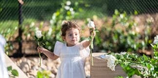 Selina Abdallah with flowers at the opening of the memorial garden for the Abdallah and Sakr children on Saturday. Photo: Giovanni Portelli