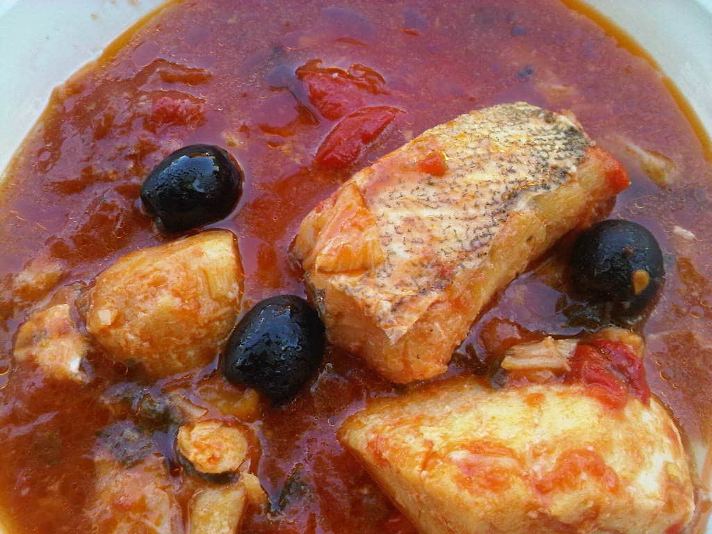Baccala with fresh tomatoes, capers, and olives. Photo: Supplied