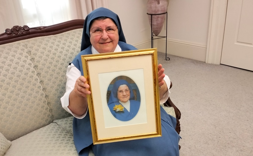 Sr Christina Pisani holds a photo of the first Australian Sister Disciples superior Mother Annunciata Stanizzi. Photo: Supplied