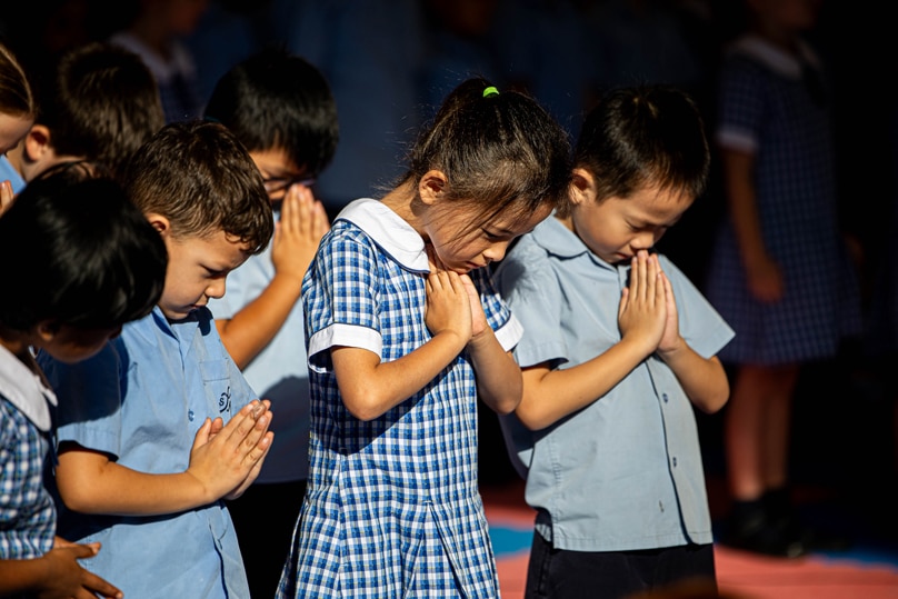 Students pray at St Michael’s Catholic Primary School. Photo: Alphonsus Fok