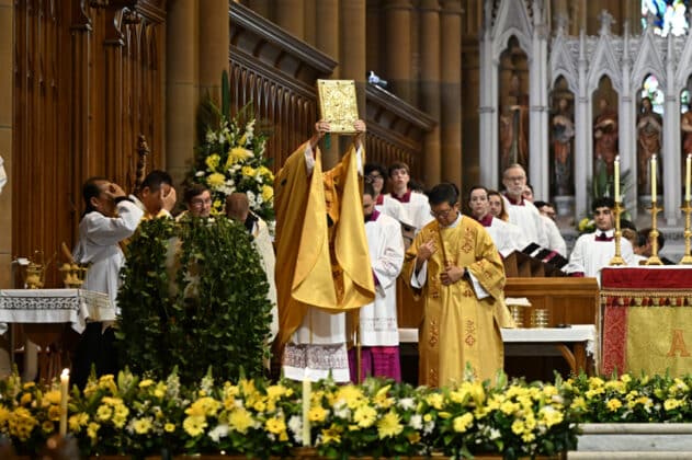 Archbishop Anthony Fisher OP Holds up the Gospel during the morning Mass of Easter Sunday of the Resurrection of the Lord. Photo: Giovanni Portelli