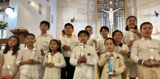 The community at St Peter Chanel and St Joseph the Worker parish welcomed 16 children from the parish schools as new members of the church through the Rite of Baptism. Photo: Supplied
