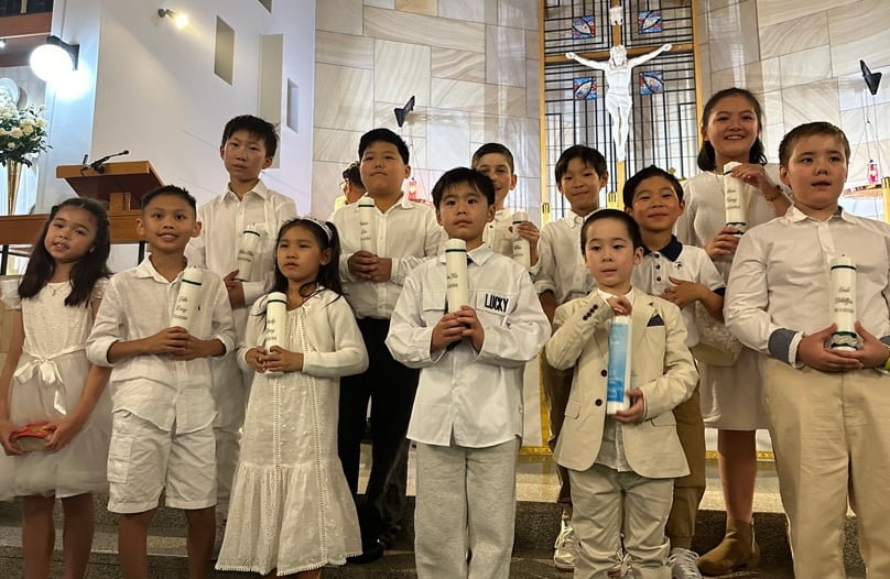 The community at St Peter Chanel and St Joseph the Worker parish welcomed 16 children from the parish schools as new members of the church through the Rite of Baptism. Photo: Supplied