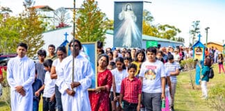 Young families were among the hundreds who took part in a solemn procession at the bushland shrine. Photo: Supplied